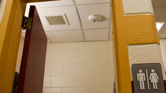 Strobe fire alarm near a school restroom doorway